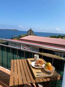una mesa con un plato de comida en el balcón en Mundaka best views house, en Mundaka