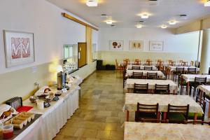 a dining room with many tables and chairs and a unintention at Turisticky Raj in Hrabušice