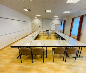 Großes Zimmer mit einem langen Tisch und Stühlen in der Unterkunft Landhotel Solmser Hof in Echzell