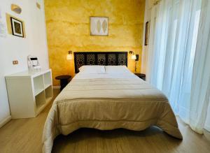 a bedroom with a large bed and a large window at B&B Everest Bar Ristorantino in Gabicce Mare