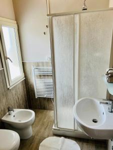 a bathroom with a shower and a sink and a toilet at B&B Everest Bar Ristorantino in Gabicce Mare