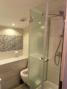 a bathroom with a toilet and a glass shower at Old Town Baska in Baška