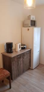 a kitchen with a white refrigerator and a microwave at Pension Rudolph Riesa in Riesa