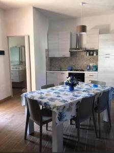 a kitchen with a table with a blue and white table cloth at VILLA FRANCA in Fontane Bianche