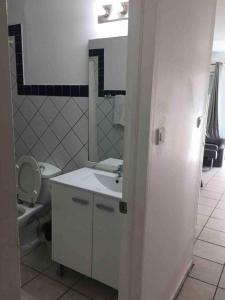 a bathroom with a white sink and a toilet at Beautiful studio Jordan Village - 5min from AUC School of Medicine in Cul de Sac
