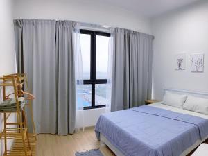 a bedroom with a bed and a large window at D'sara Sentral Sovo in Sungai Buluh
