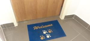 a welcome mat on the floor in front of a door at Old Town Baska in Baška