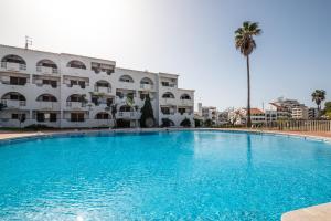 a large swimming pool in front of a building at #085 Pool View, Center City with AC in Albufeira