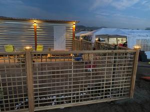a wooden fence in front of a tiny house at Cerrado in El Porvenir