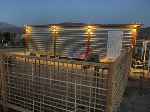 a building with a deck with plants on it at Cerrado in El Porvenir