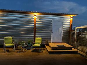 a patio with two chairs and a table and a building at Cerrado in El Porvenir