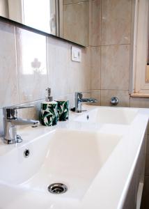 a bathroom with a white sink and a mirror at VEGA DEL CARMEN in Teruel +31 photos