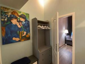 a walk in closet with a painting on the wall at K&S Apartments in Berlin