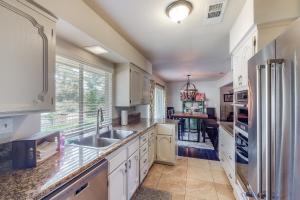 a kitchen with white cabinets and a sink at Putney Place in North Fork