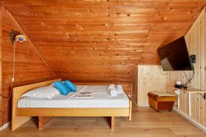 a bedroom with a bed in a room with wooden walls at Vukićević House in Kotor