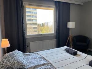 Un dormitorio con una cama grande y una ventana en STAY Matinkatu Apartment, en Espoo