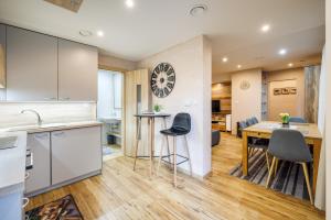 a kitchen and dining room with a table and chairs at Apartman Nosek in Donovaly