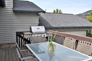 a grill and a glass table on a balcony at Hood River Family Vacation Home in Hood River +5 photos