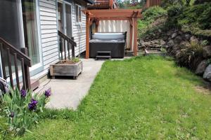 a backyard patio with a couch on the side of a house at Hood River Family Vacation Home in Hood River
