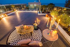 a balcony with a table and candles on a building at Olivia Beach Sea and Sky Pool Villa Huahin in Ban Bo Fai (1)