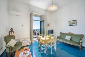 a living room with a table and chairs at Lu Penniell in Amalfi