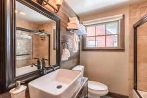 a bathroom with a sink and a toilet and a mirror at Lakeview Manor in South Lake Tahoe +16 photos