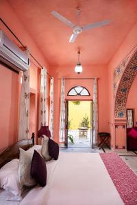 a bedroom with a large bed and an open doorway at Diggi Palace A Luxury Heritage Hotel in Jaipur