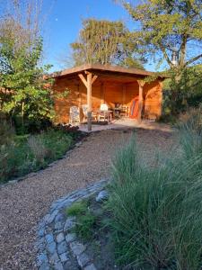 a log cabin with a porch and a patio at Kustverhuur, Breskens, 't Zandertje in Breskens