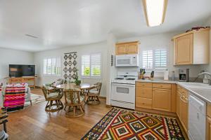 a kitchen with wooden cabinets and a table with chairs at South Bay Delight in Imperial Beach