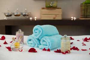a blue towel and a bottle of liquid on a bed at Radisson Blu Hotel, Jeddah Corniche in Jeddah
