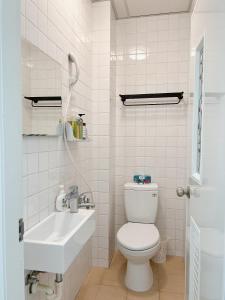 台南的住宿－旅樂台南民宿，白色的浴室设有卫生间和水槽。