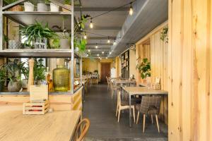 a restaurant with tables and chairs and plants at Przystanek Tleń in Tleń