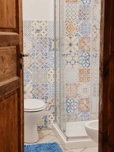 a bathroom with a toilet and a shower at La Casa di Ele in Sutri