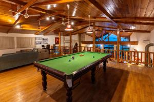 a pool table in the middle of a living room at Tree of Life Junoon in the Hills Kumaon in Nainital