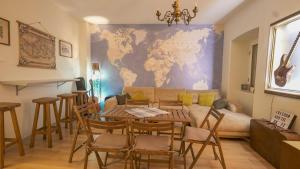 a living room with a couch and a table and chairs at FREEDOM HOSTEL in Budva