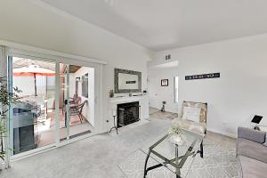 a living room with a couch and a fireplace at Monarch Vista in Dana Point