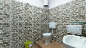 a bathroom with a toilet and a sink at Kaka Ji Palace By WB Inn in Agra