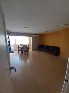 an empty living room with a table and a couch at Departamento en el centro de la ciudad in Encarnación