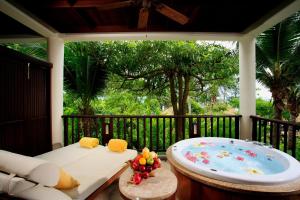 a bath tub sitting on a porch with a tree at Centara Grand Beach Resort & Villas Krabi in Ao Nang Beach