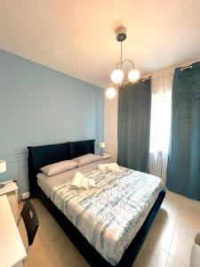 a bedroom with a large bed with blue walls at Lugaro Guest House in Turin