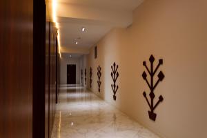 a hallway in a house with black wall art at Giowine Hotel & Restaurant in Cricova
