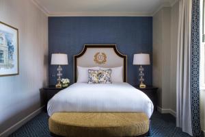a bedroom with a large bed and a large mirror at Willard InterContinental Washington, an IHG Hotel in Washington, D.C.