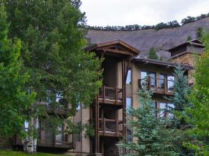 a large apartment building with balconies and trees at Woodbridge Condo by Snowmass Vacations in Snowmass Village