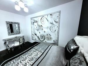 a bedroom with a large wall mural with a bed and a desk at Apartament Glamour in Gniezno