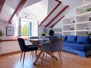 a living room with a blue couch and a table at Apartments Sandra in the historical center of the city in Supetar