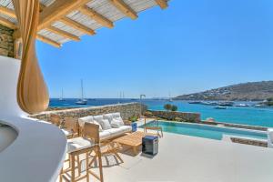 a villa with a view of the ocean at The Absolute beachfront luxury villa in Platis Yialos Mykonos