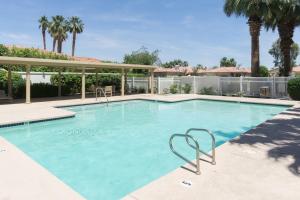 a large swimming pool with blue water at Southern Hills Charm Permit# 65256 in La Quinta