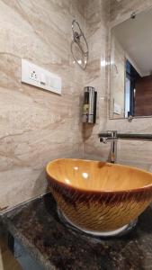 a bathroom with a large wooden sink on a counter at Hotel BlueArk in Lucknow