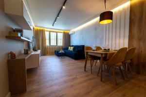 uma sala de estar com uma mesa e um sofá azul em Top location,Sea ​​View and luxury apartments in Symphony residence em Varna City