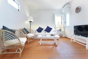 a living room with a couch and chairs and a tv at Seagull Rooftop Beach @150 m in Vale do Lobo